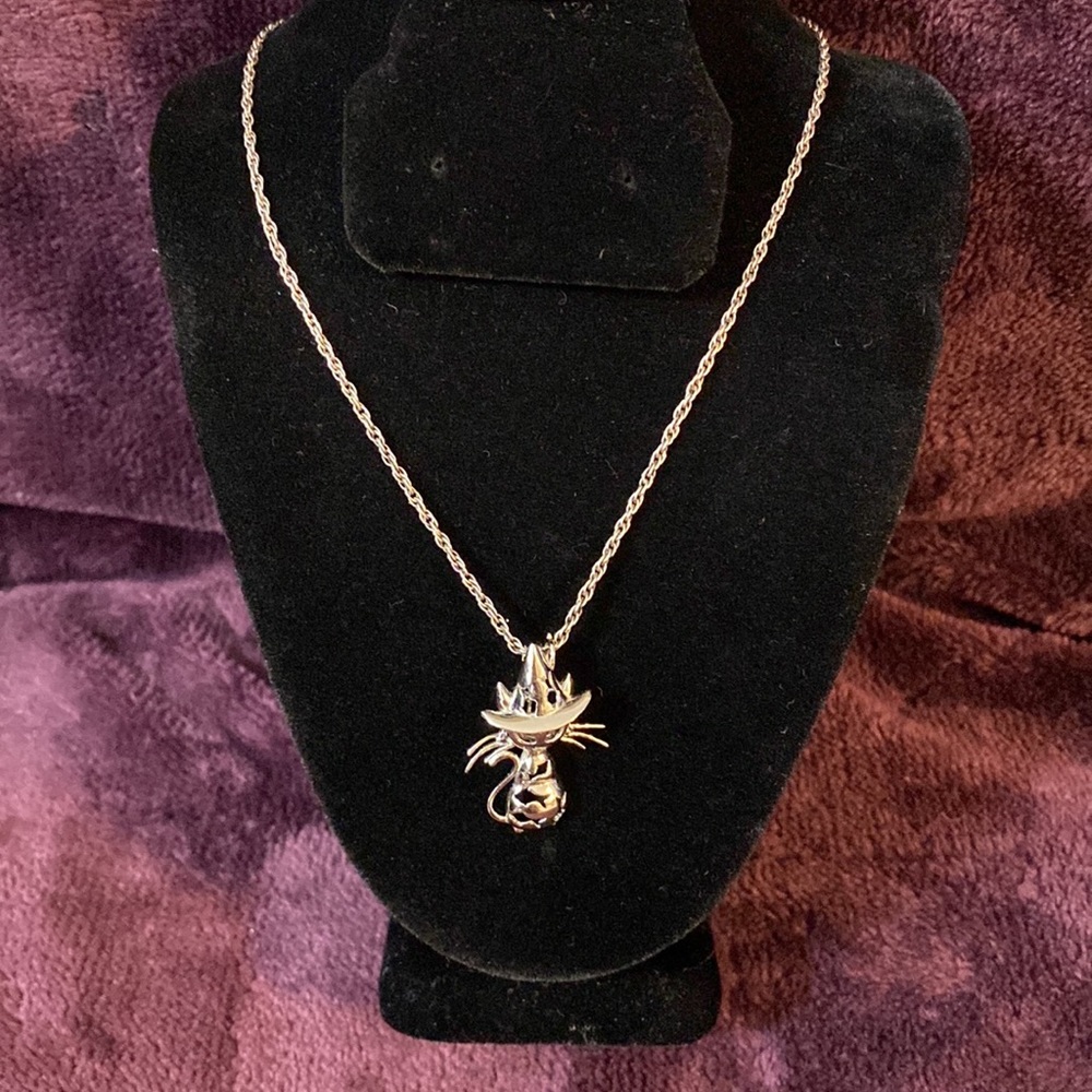 Sterling Silver cat charm with a hidden spot.